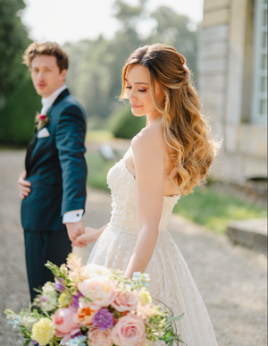 Elegant wedding photo series showing a bride holding a colorful bouquet in an outdoor setting.