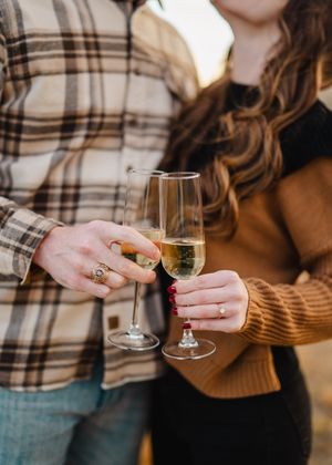 Close-up of hands holding champagne glasses during a celebration.