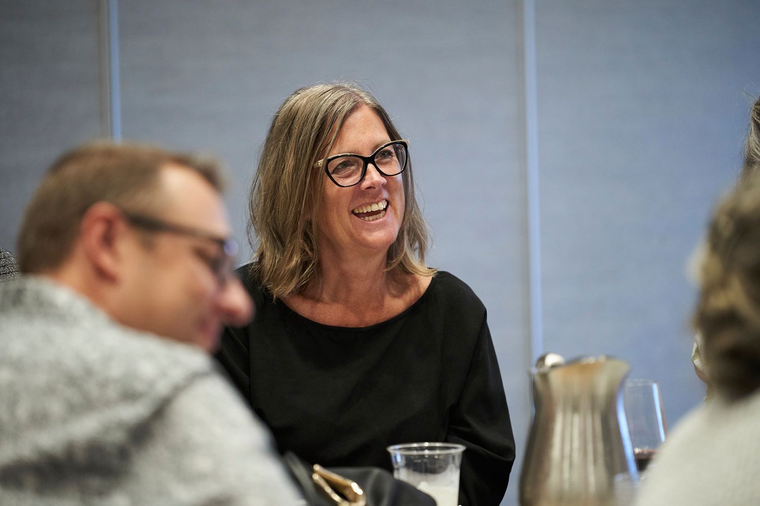 Engaging conversation during a social gathering with drinks and laughter.