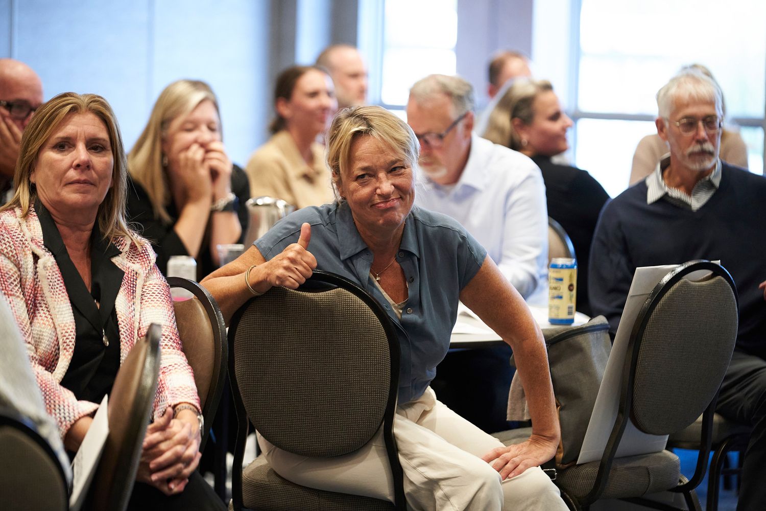 Engaged audience members participate enthusiastically during a conference session.