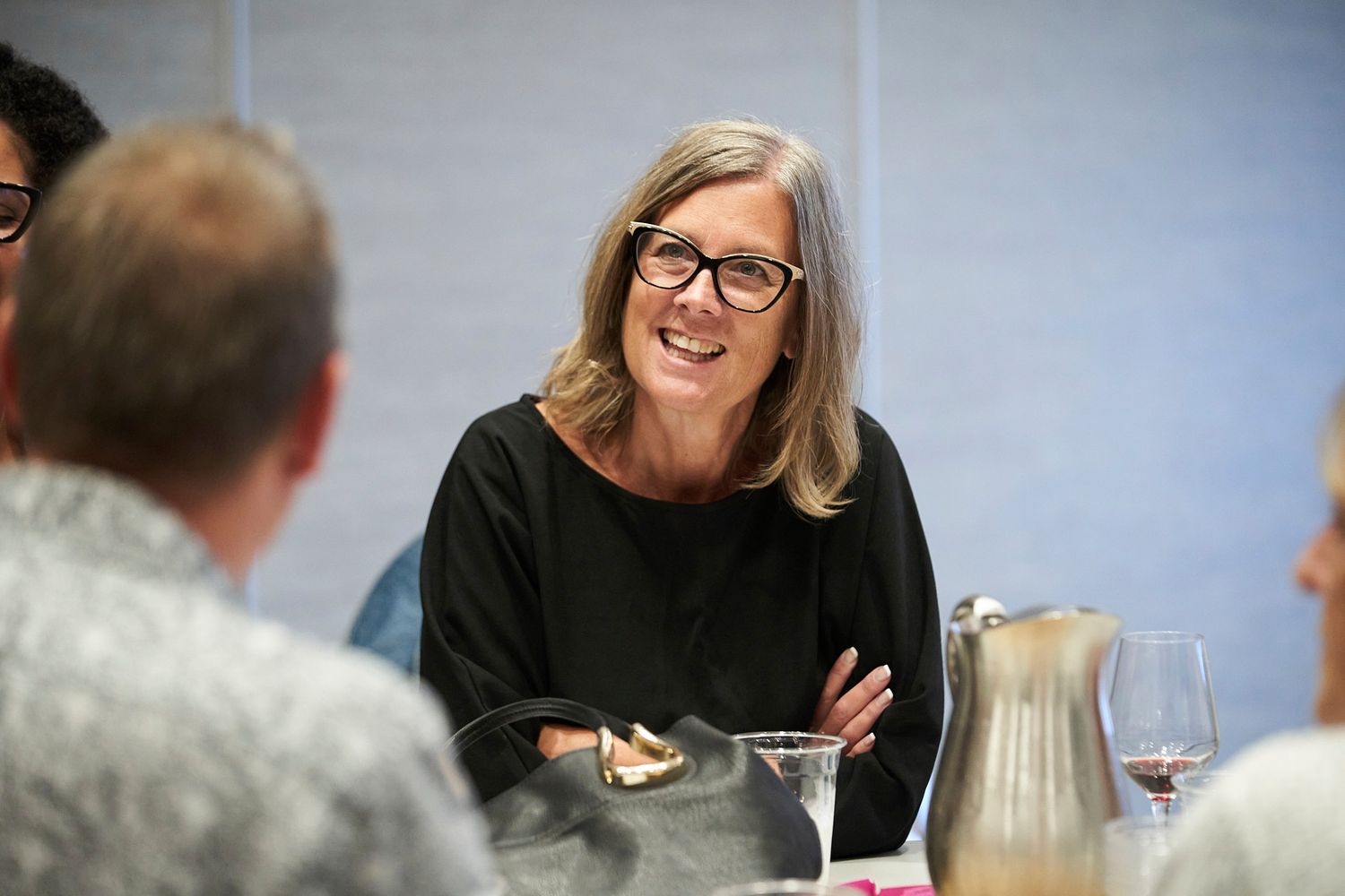 An animated discussion takes place over drinks and appetizers at a social gathering.
