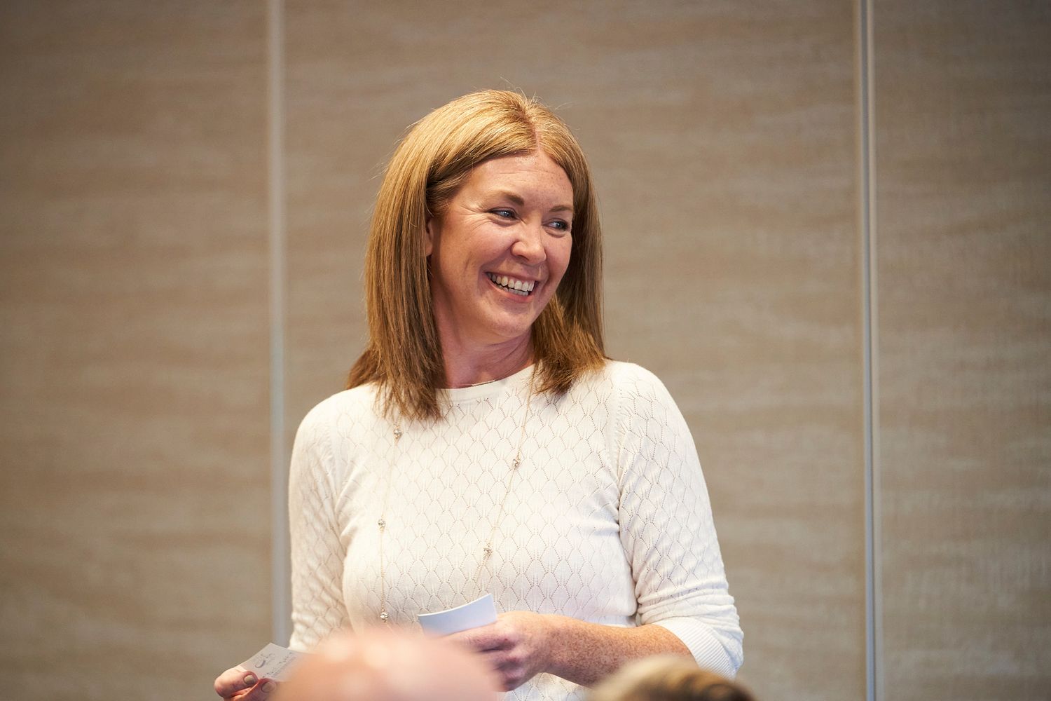 Candid moment of joy captured during a professional networking event.