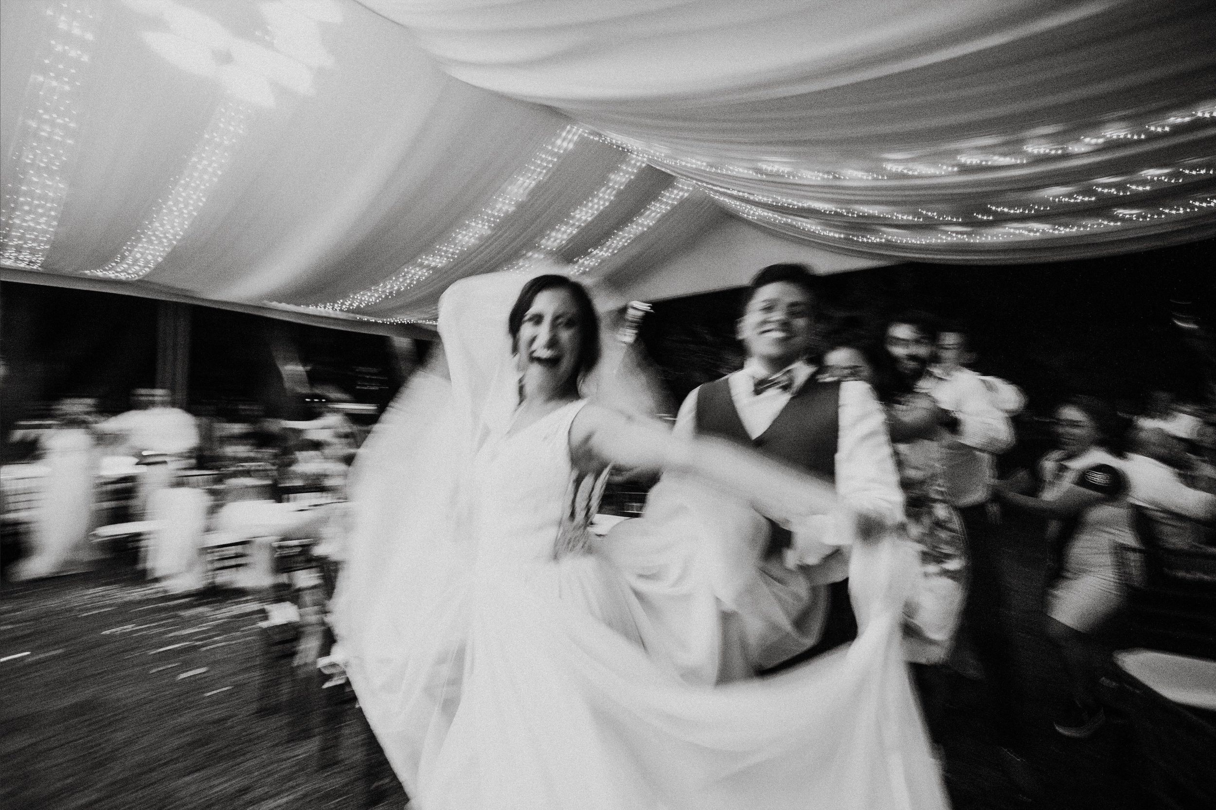 Multiple dance sequences at a wedding celebration shown in blurred motion on a dark background.