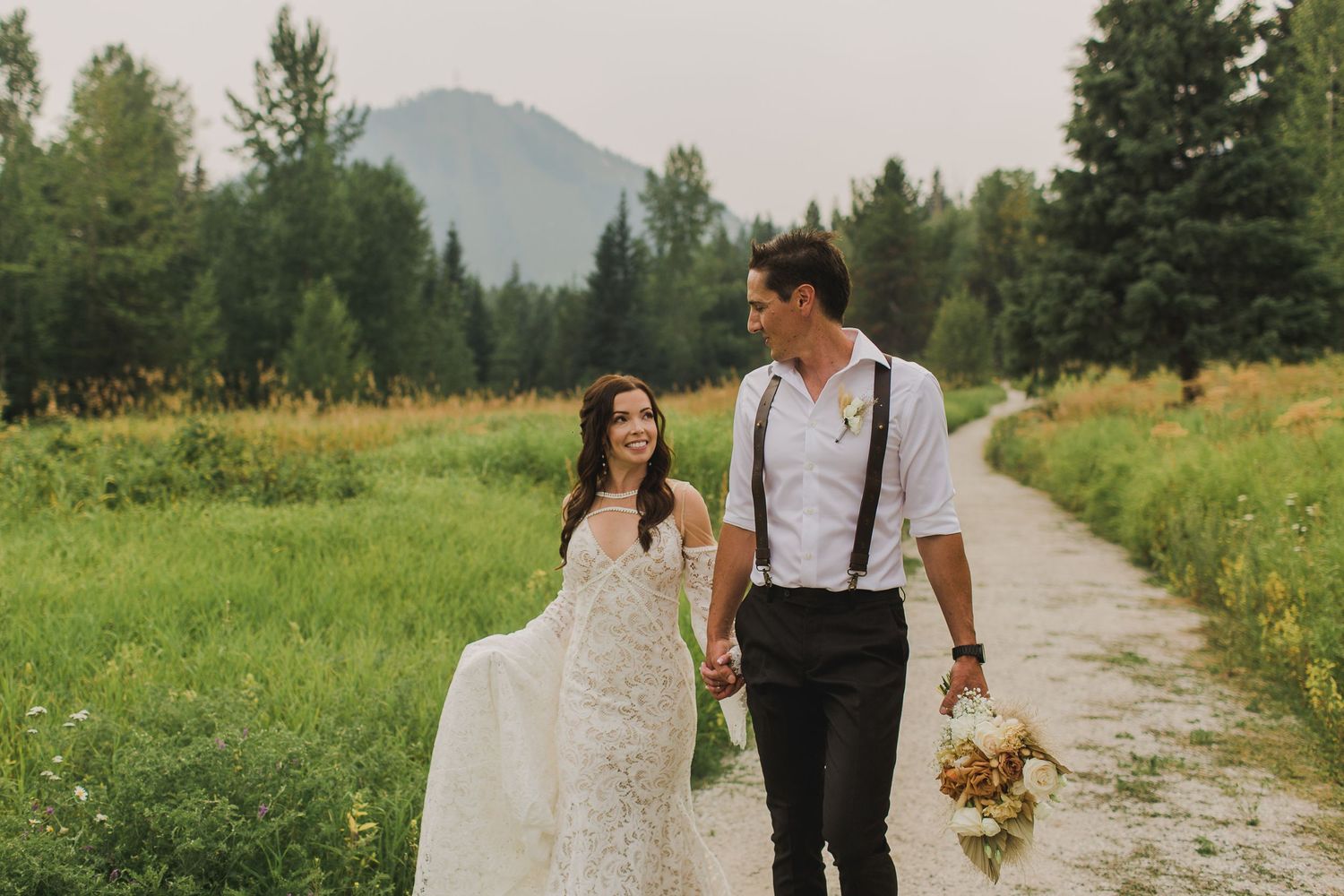 A couple walks in a meadow near Rossland BC
