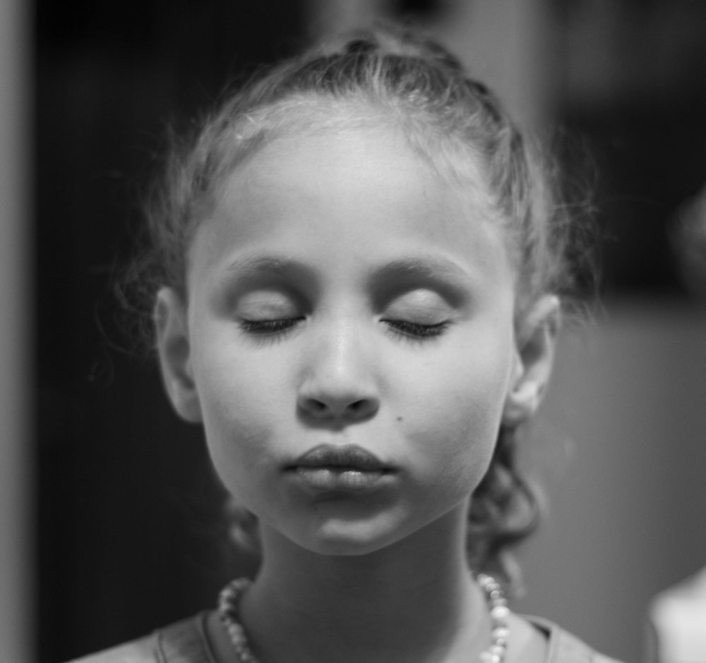 Black and white portrait with closed eyes and serene expression.