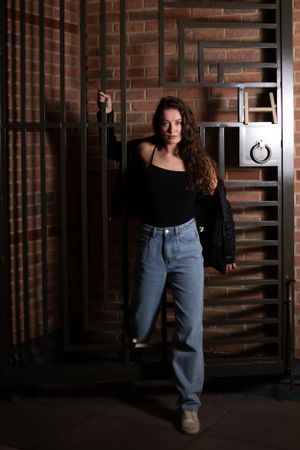 Teen-hanging-on-a-gate-at-the-H-Hotel-In-Midland-Michigan.