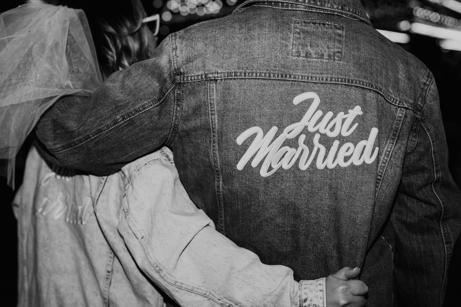 Close up of denim jacket with 'Just Married' text embroidered on back.