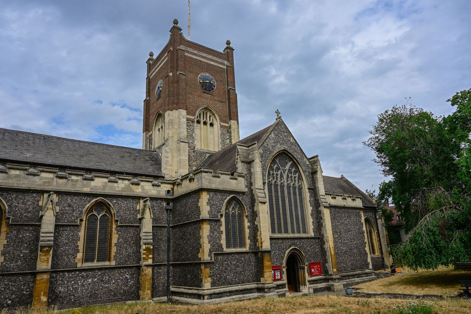Gothic church exterior with tall bell tower and ornate stone architectural details.