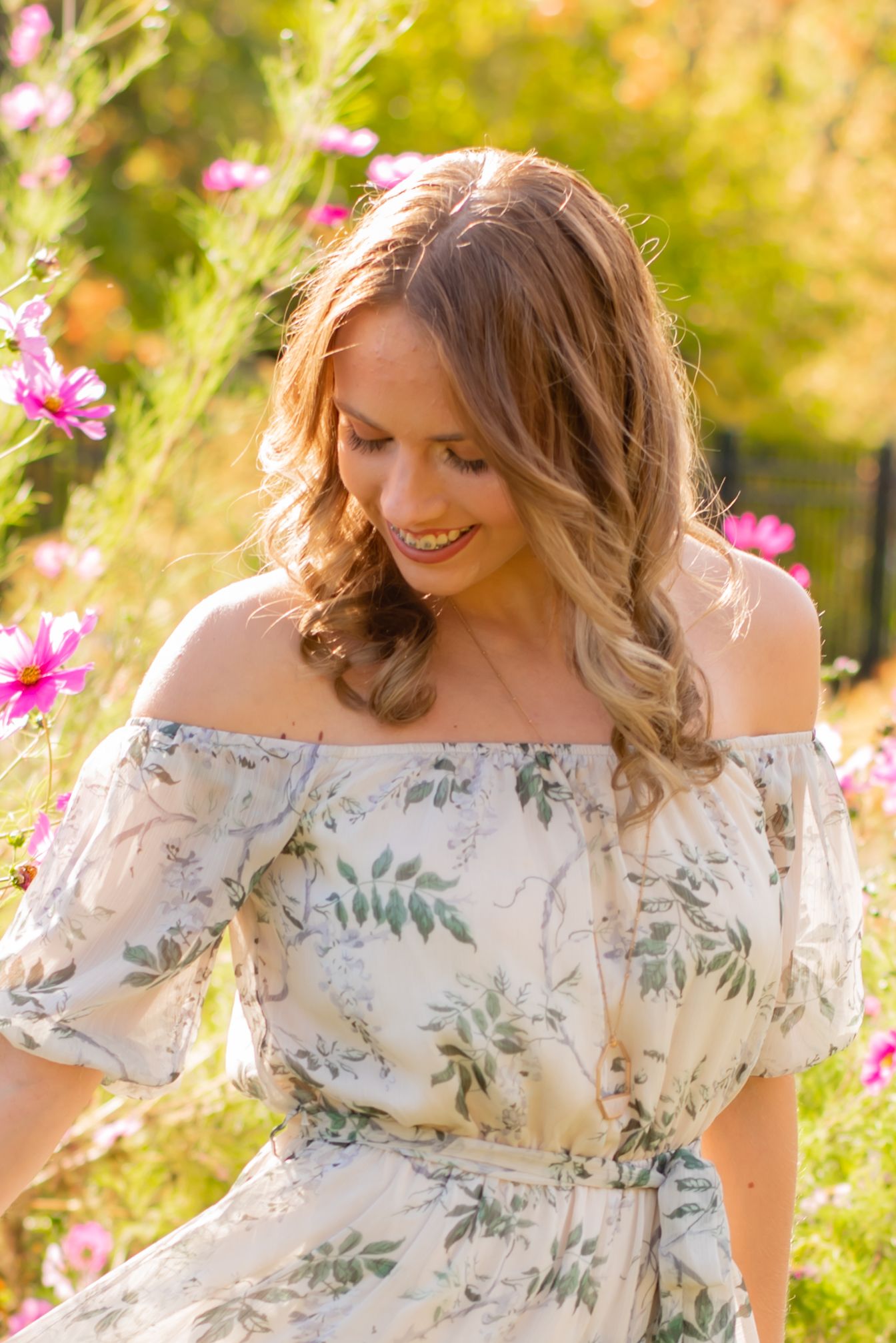 senior girl in flower dress in the flower garden at hartwood acres on a summer day