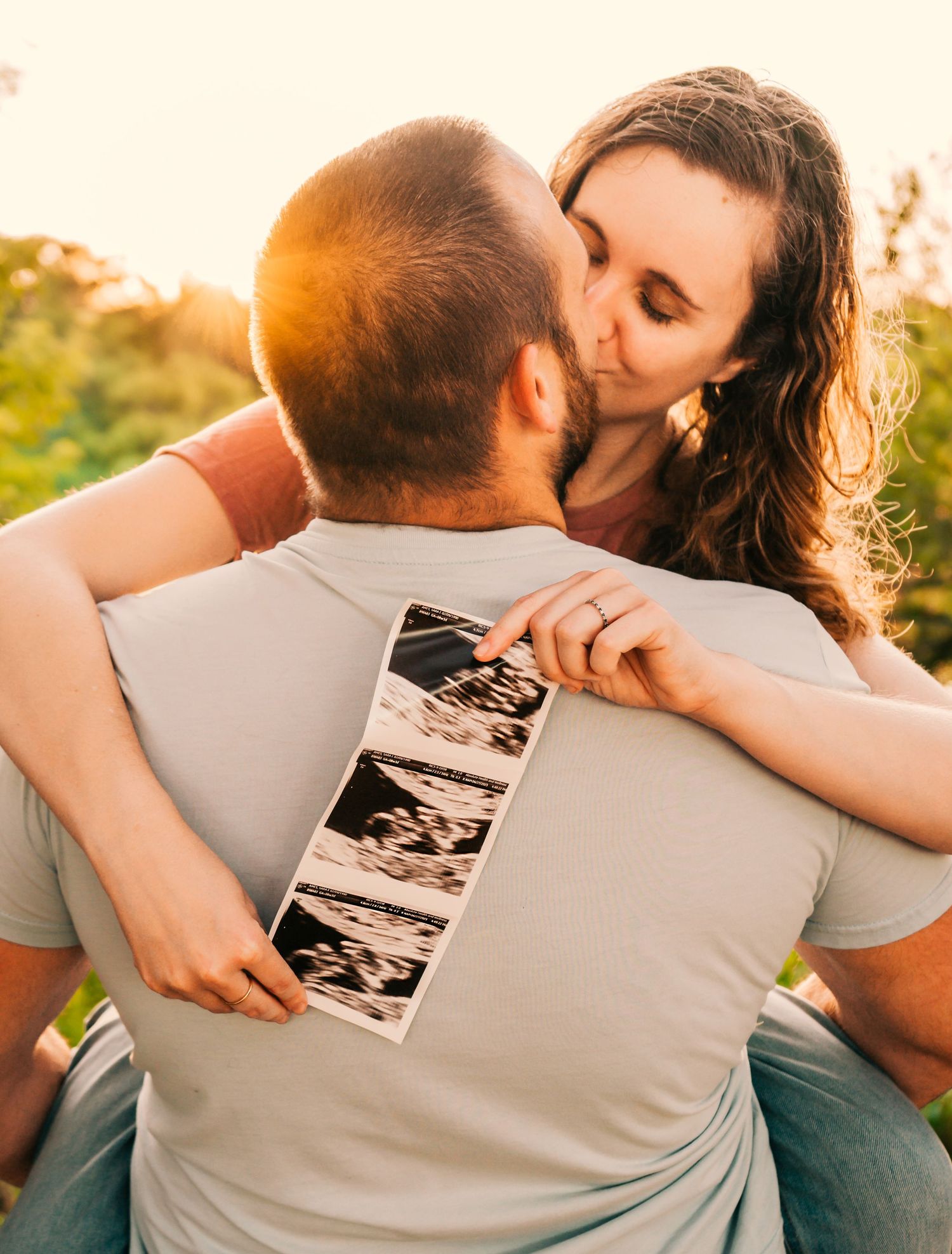 Outdoor Milestone Session at Walter Fuller Park, Pinellas Park, FL; Pregnancy announcement, couple with sonogram announcing pregnancy