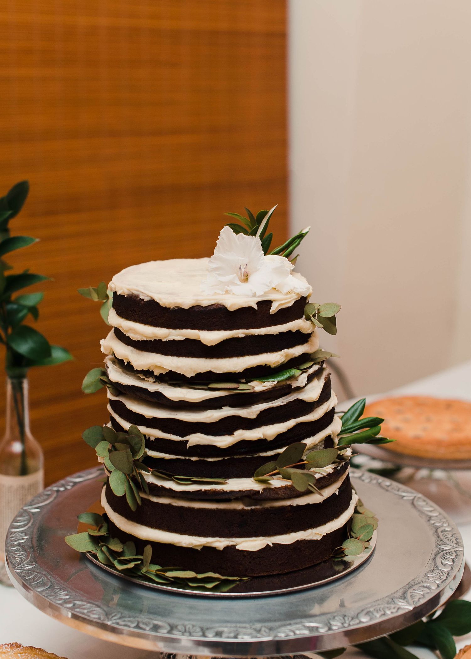 chocolate wedding cake with flower on top.
