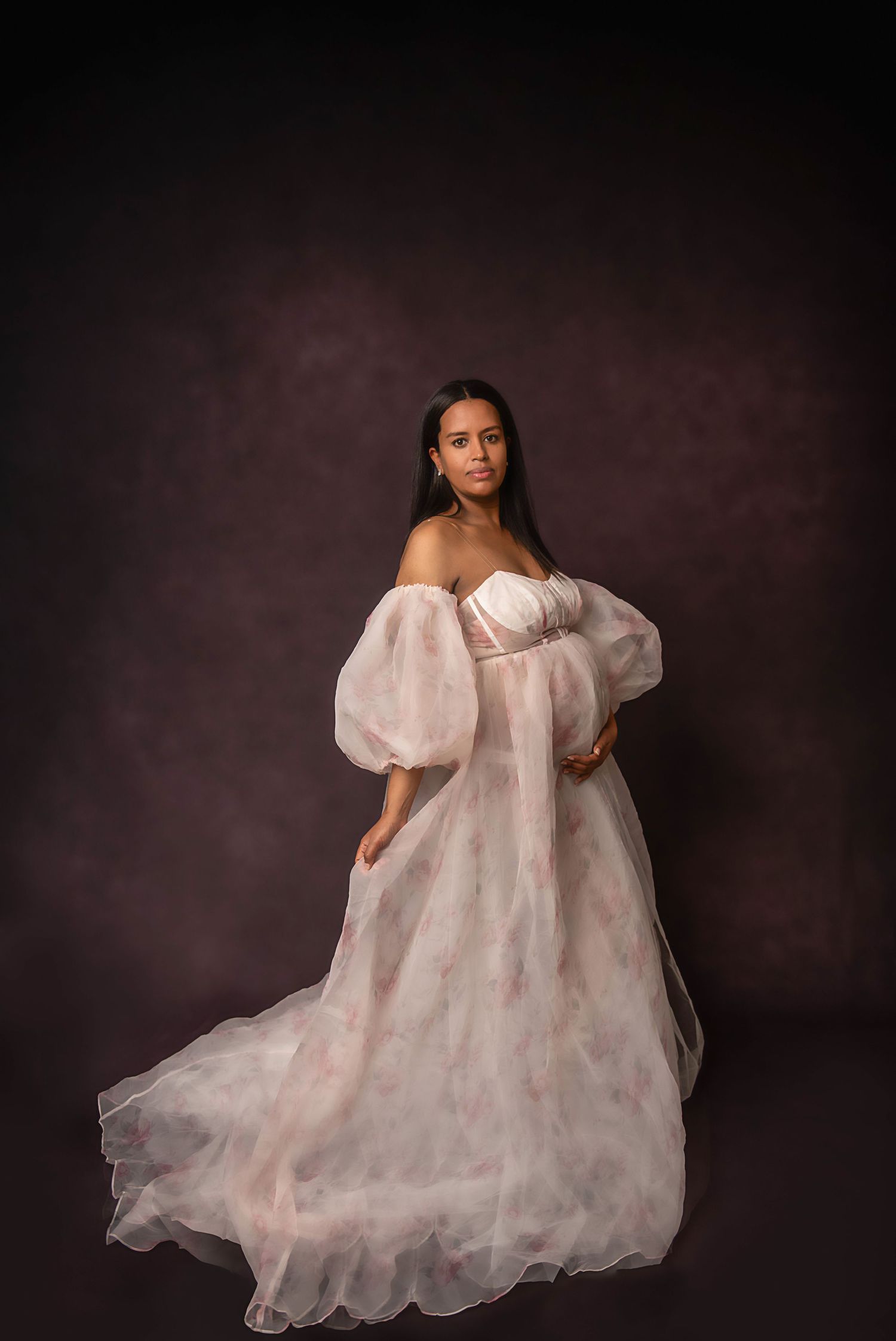 Ethereal portrait series featuring flowing white dress against dark studio background.