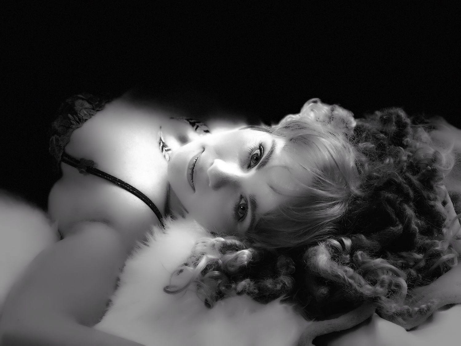 Dramatic black and white close-up portrait with soft lighting.