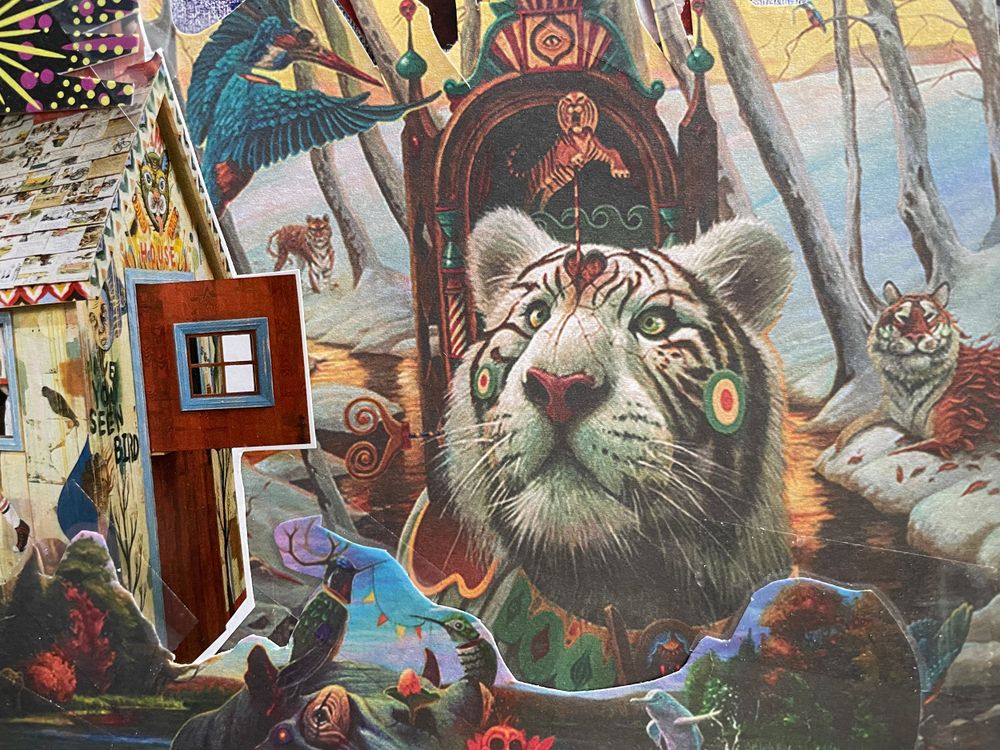 Artistic collage featuring white tiger amid colorful fantasy elements.