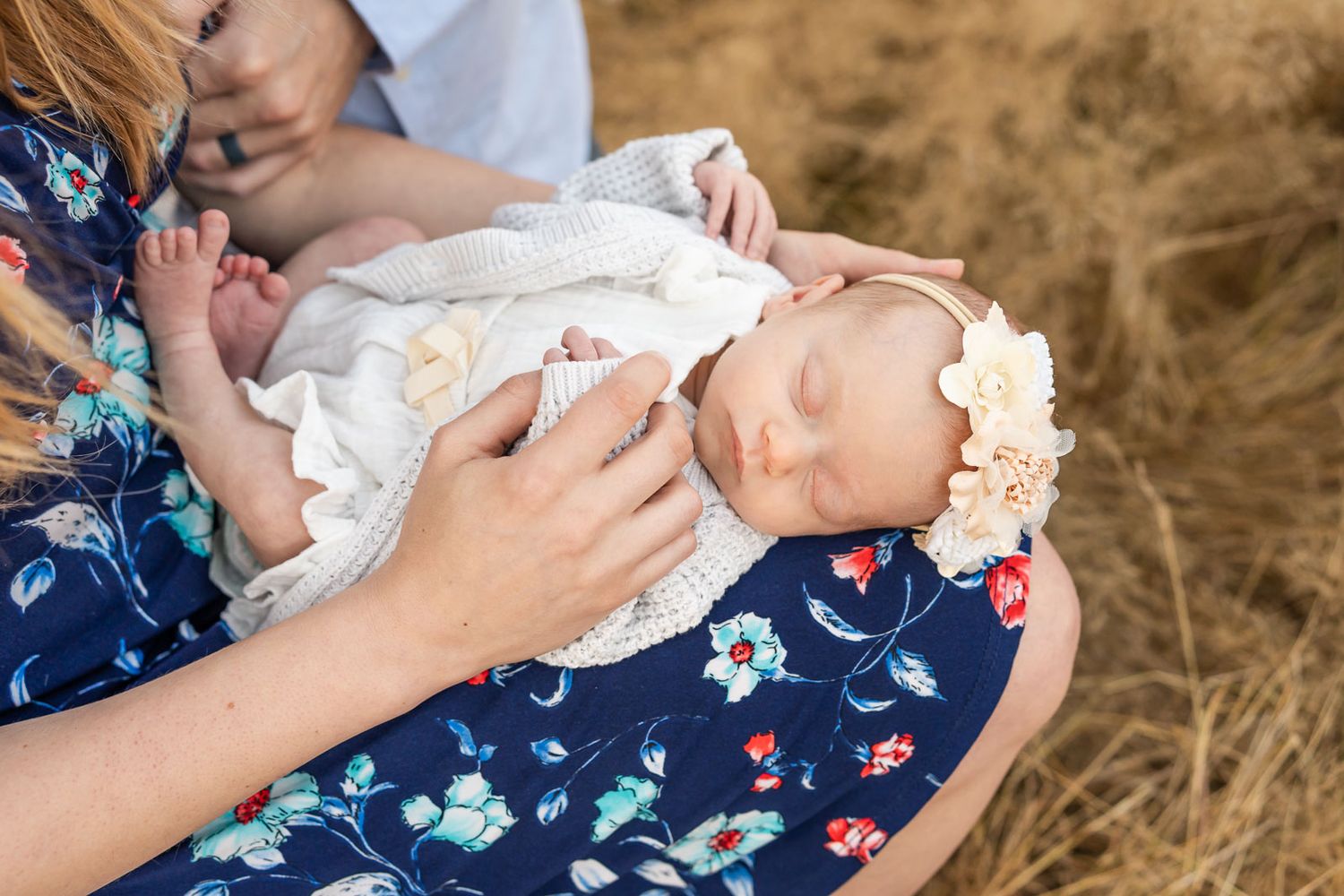 Portrait of sleeping newborn baby in mother's lap