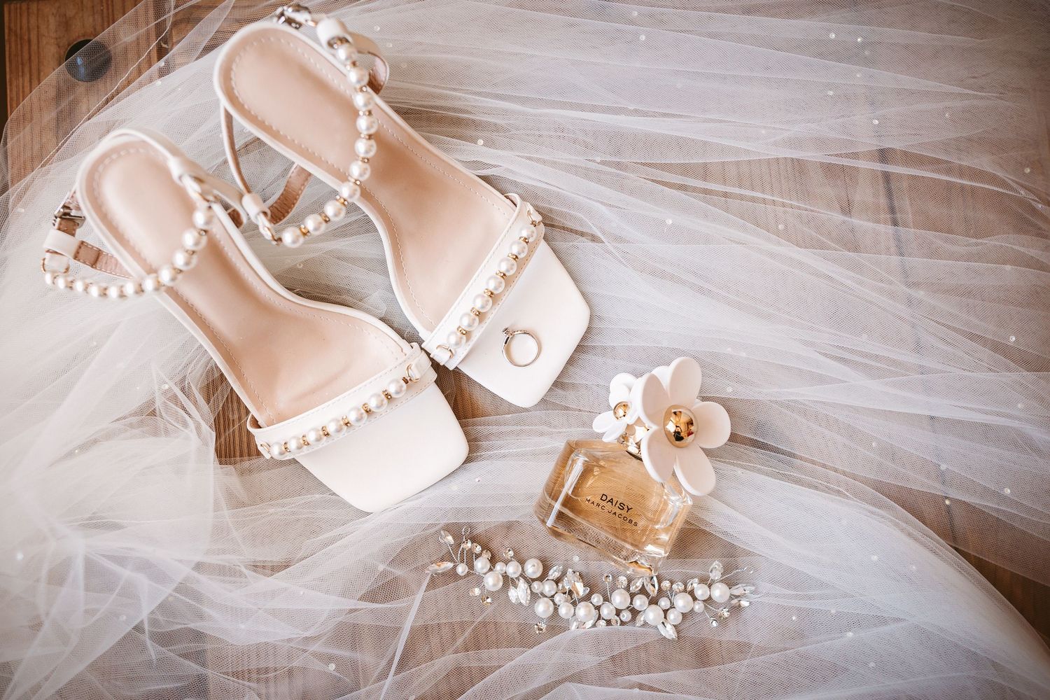 Bride details in flat lay showing shoes, veil, perfume jewellery and tiara