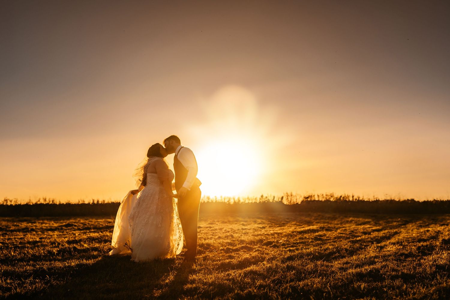 magical Bride and Groom golden hour sunset kissing Stone Barn The Cotswolds looks like film painting
