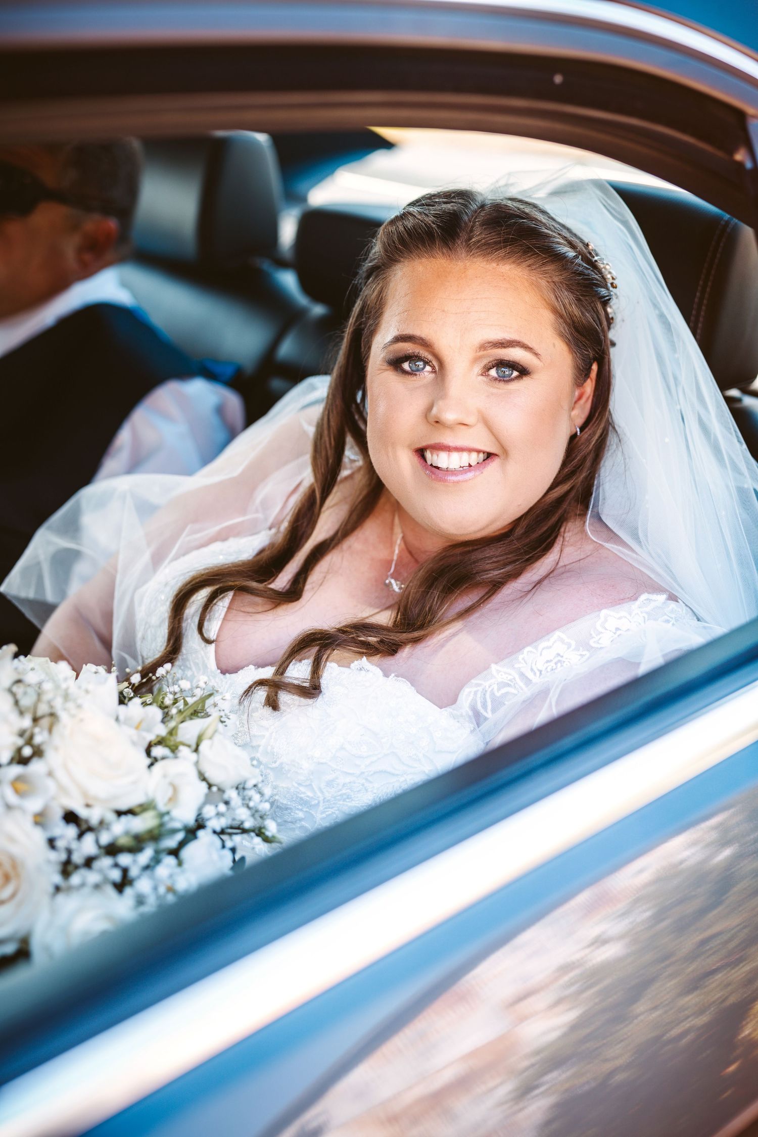 Beautiful Blue eyed bride waiting in car before going in to the ceremony