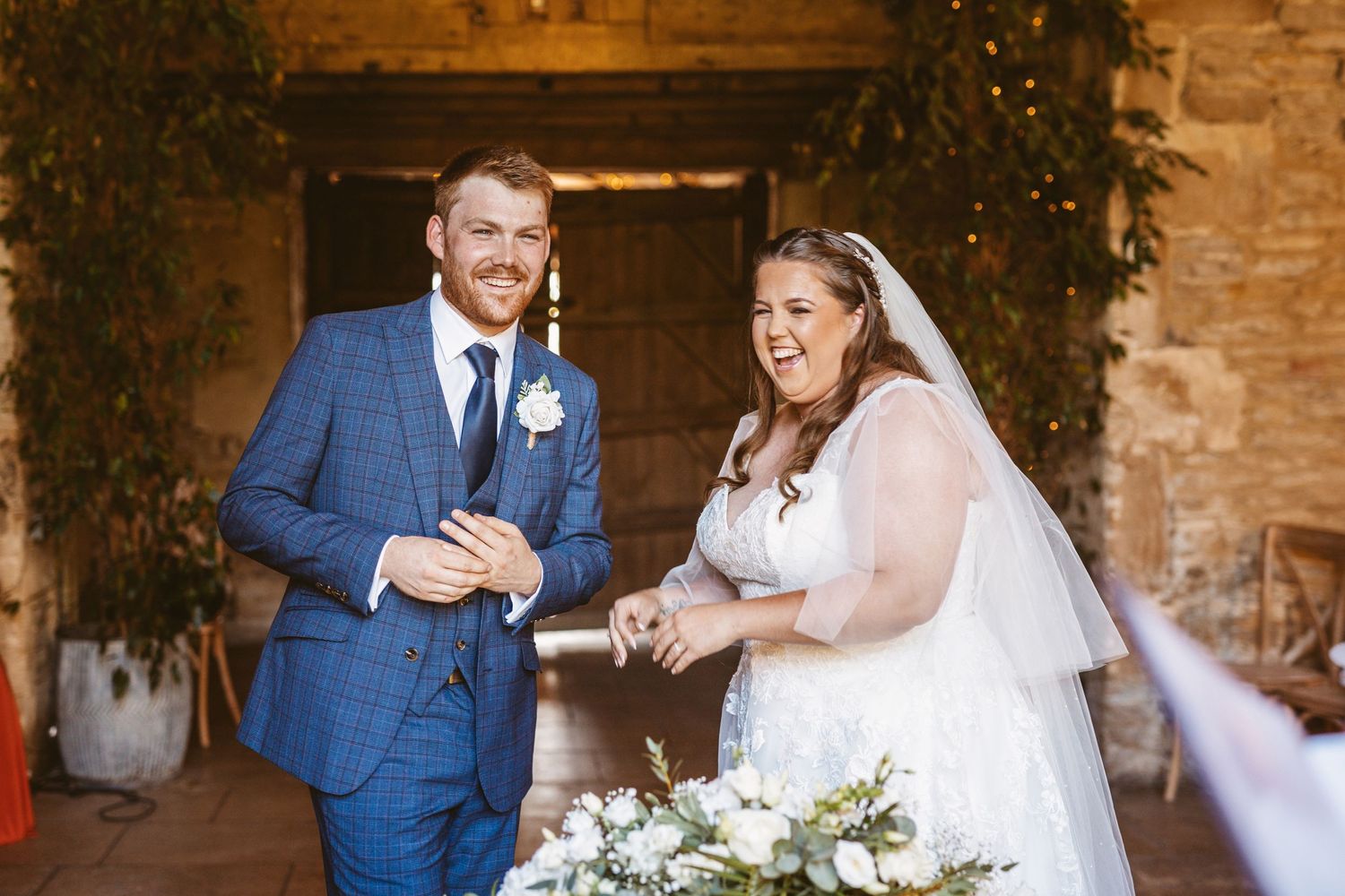 Bride and Groom getting giggles during wedding ceremony Stone Barn Wedding Venue Cheltenham The Cotswolds