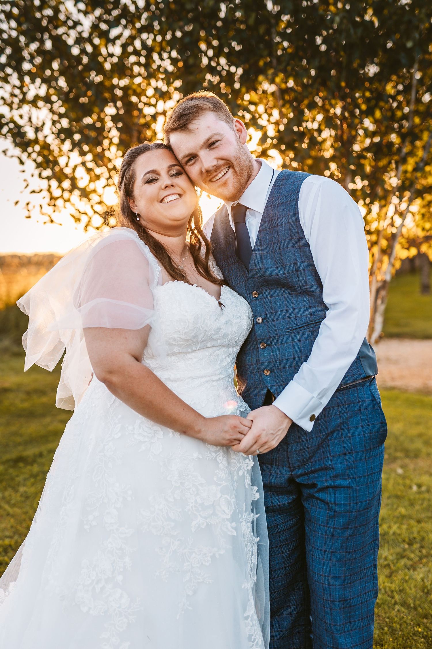 Bride and Groom holding hands in golden hour sunset Stone Barn The Cotswolds