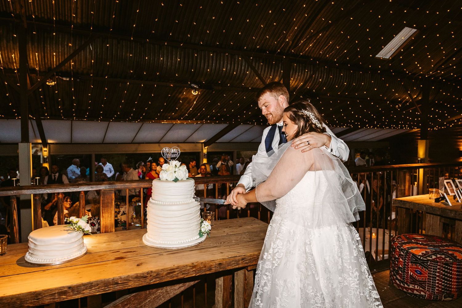 Cutting the cake Bride and Groom Stone Barn The Cotswolds