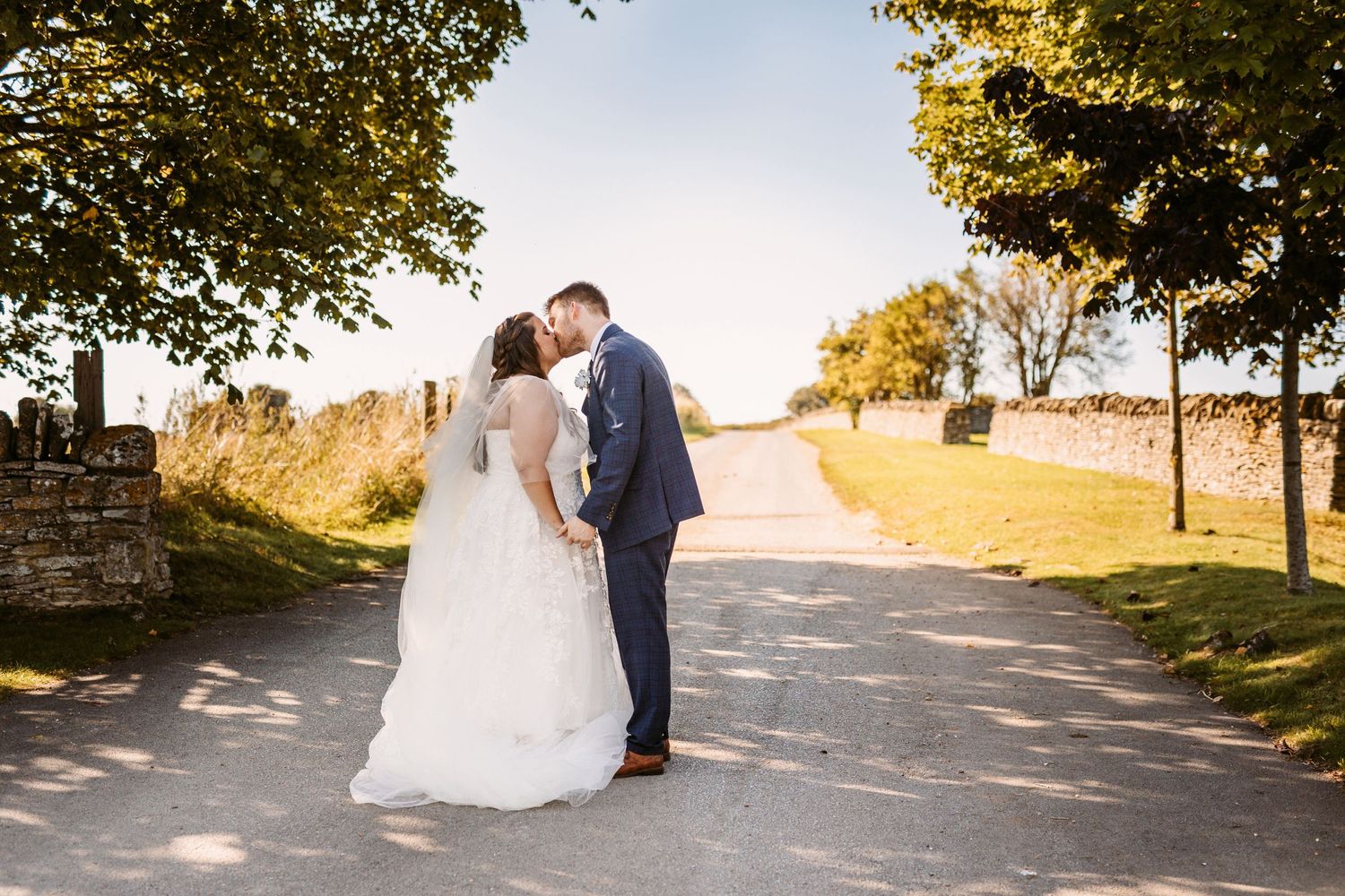 Bride and Groom portrait of beautiful couple kissing at  Stone Barn wedding venue