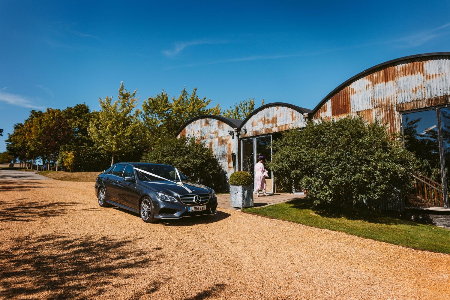 Brides car arriving at Stone Barn Wedding Venue Cheltenham The Cotswolds