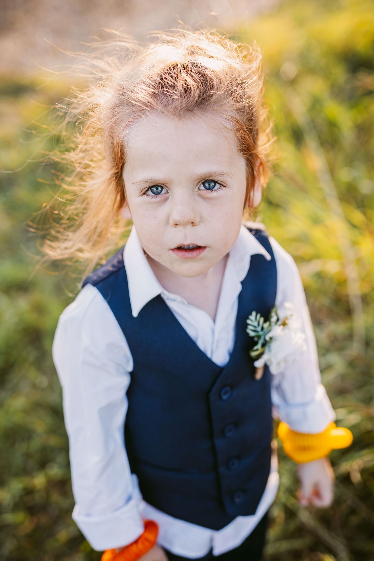 Cool kid at Stone Barn wedding venue wearing waistcoat and hair tied back