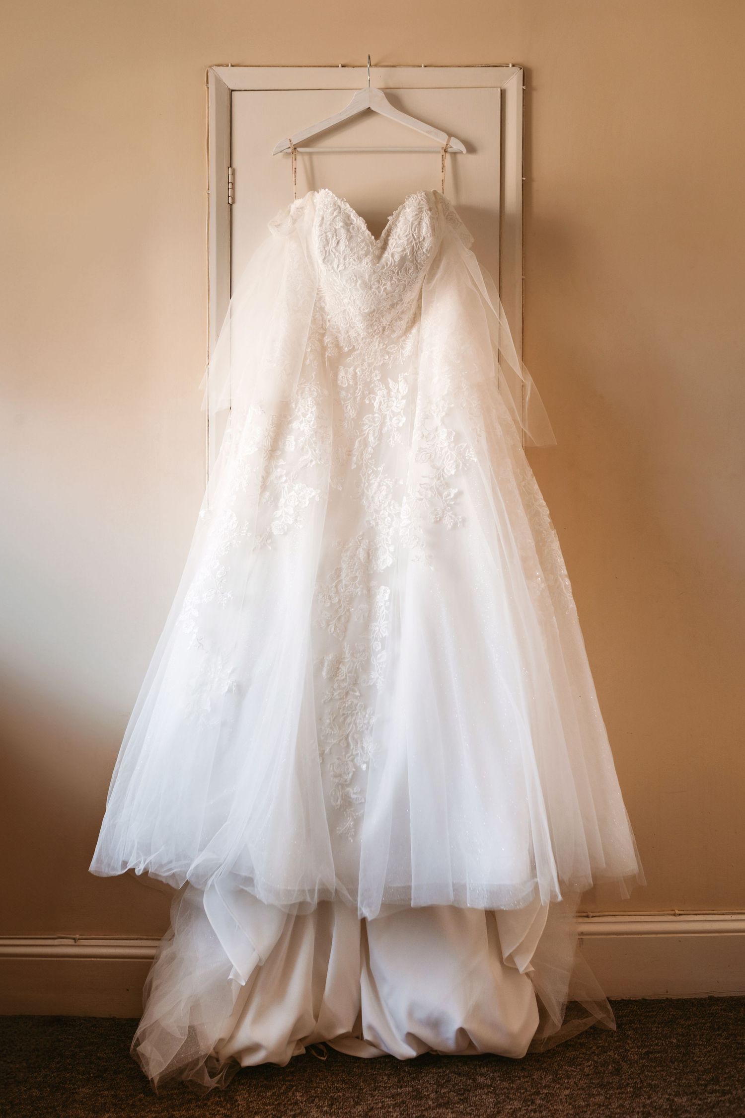 Wedding Dress hanging up before bride wears it for the ceremony
