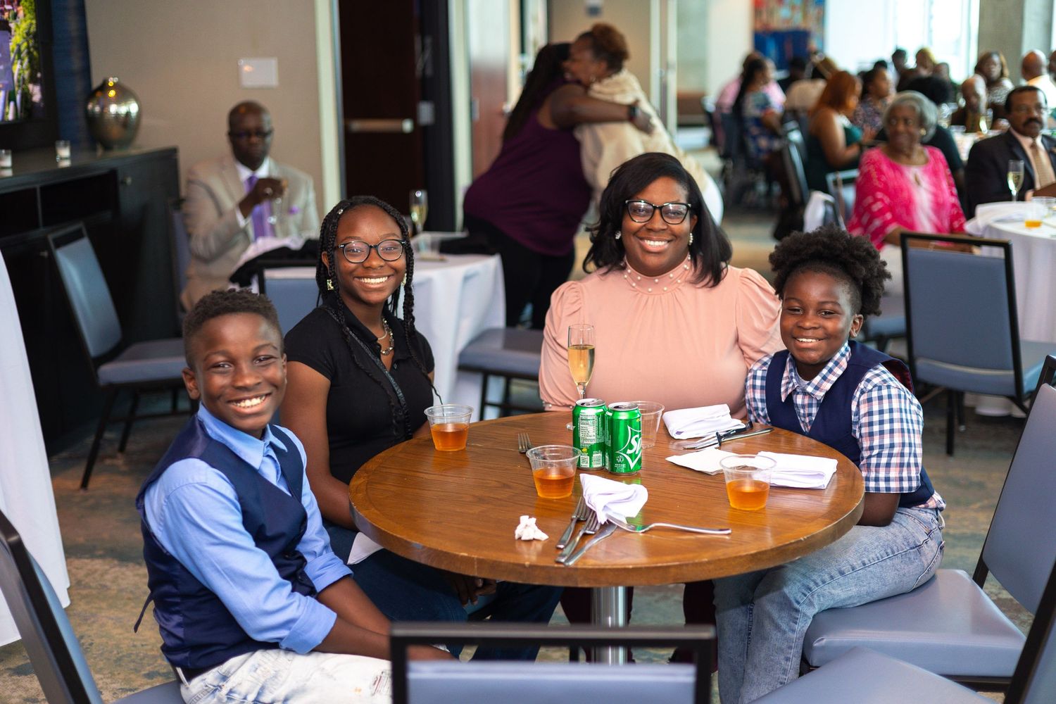 Group enjoying a casual meal together at a round table in a restaurant.