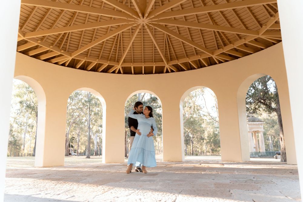 Dancing in the parramattapark rotunda during maternity photoshoot