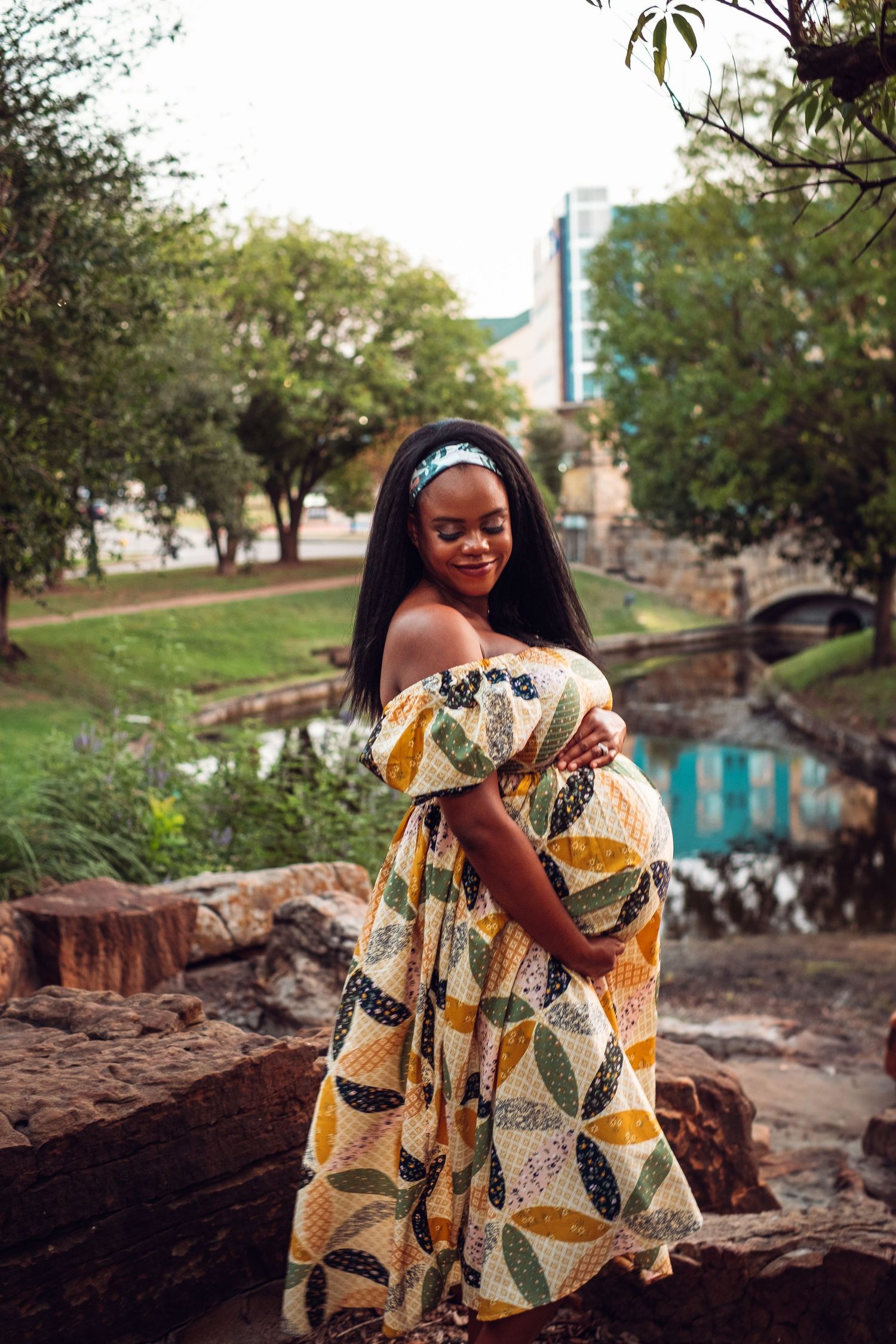 Fashion photography in park setting featuring flowing yellow patterned dress.
