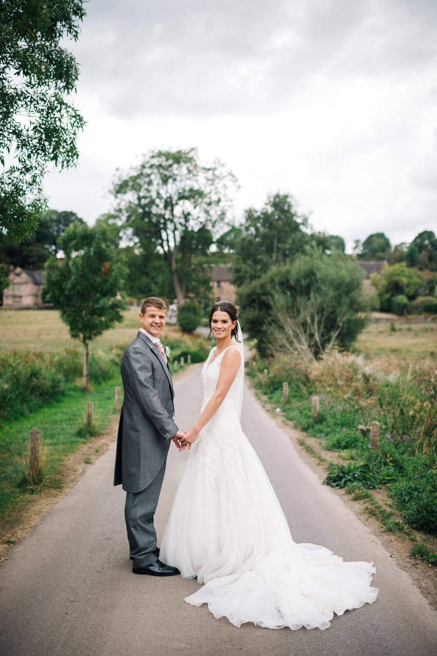 The Ashes Wedding venue, Barn wedding, bride and groom on the driveway, groom in tails