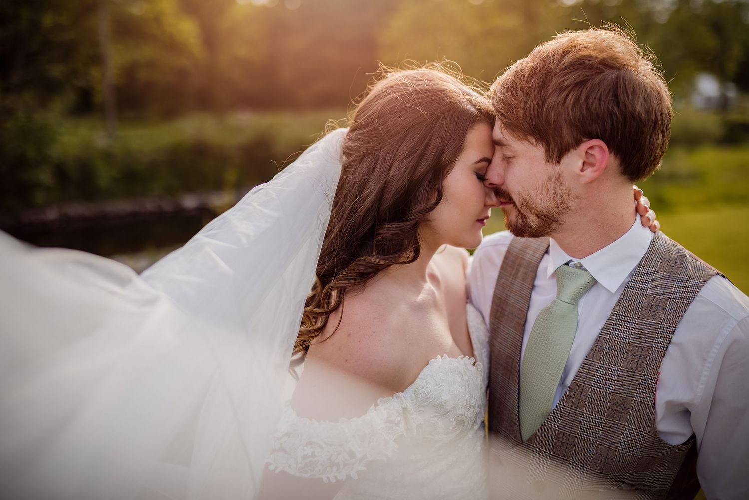 Close-up wedding portrait capturing an intimate moment between newlyweds.
