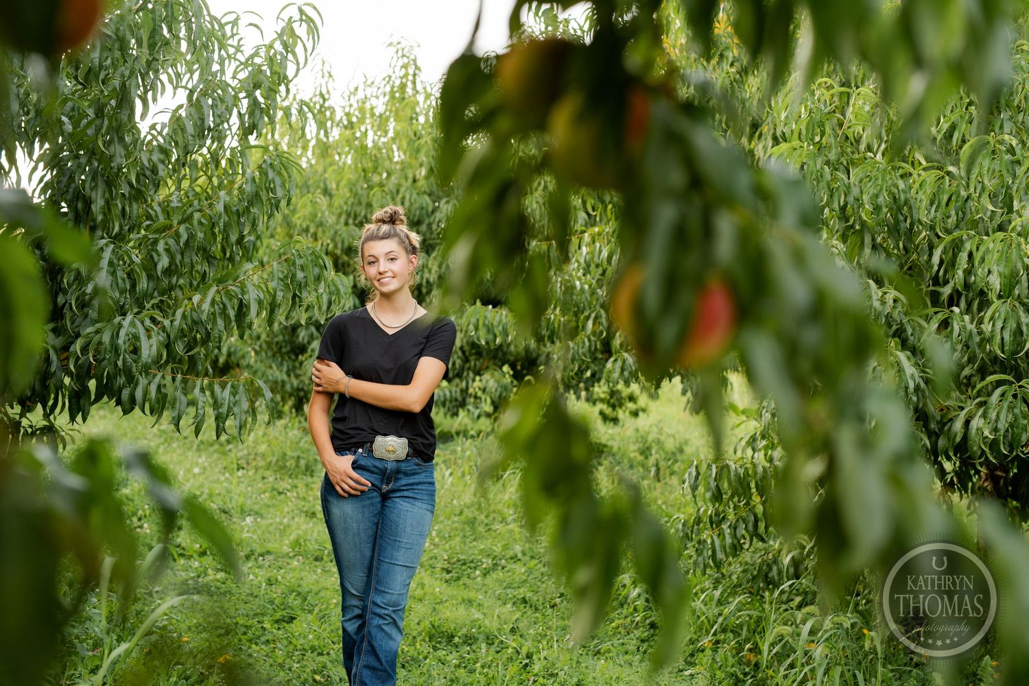 Candid shot walking through peach orchard rows during golden hour.
