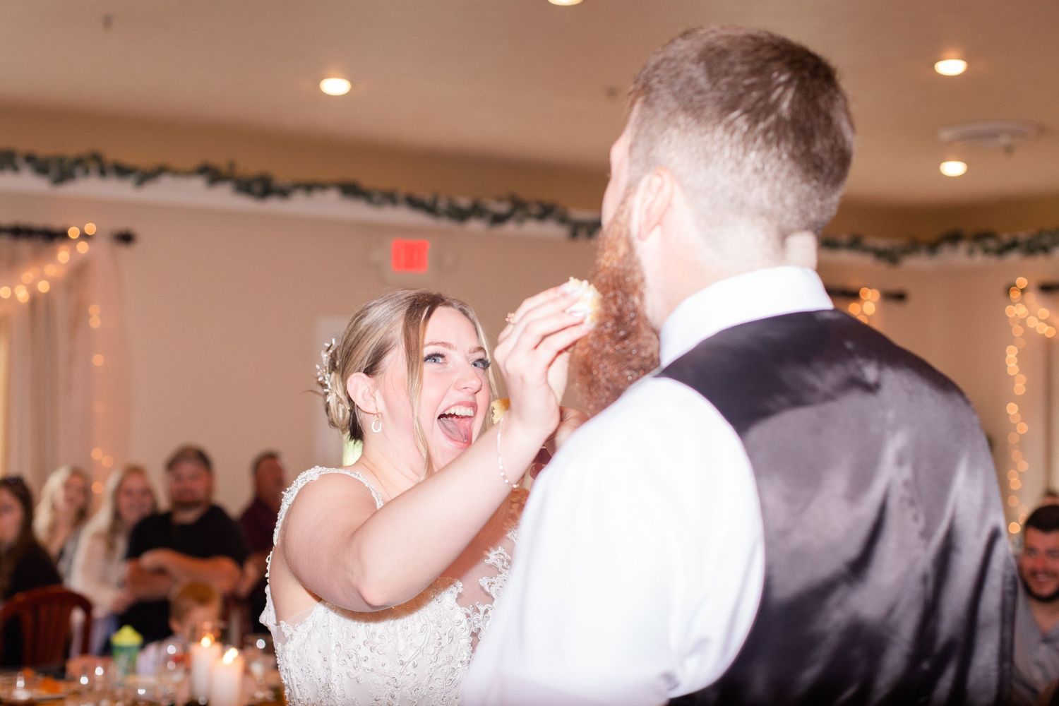 Wedding celebration in a banquet hall decorated with twinkling lights and garlands.
