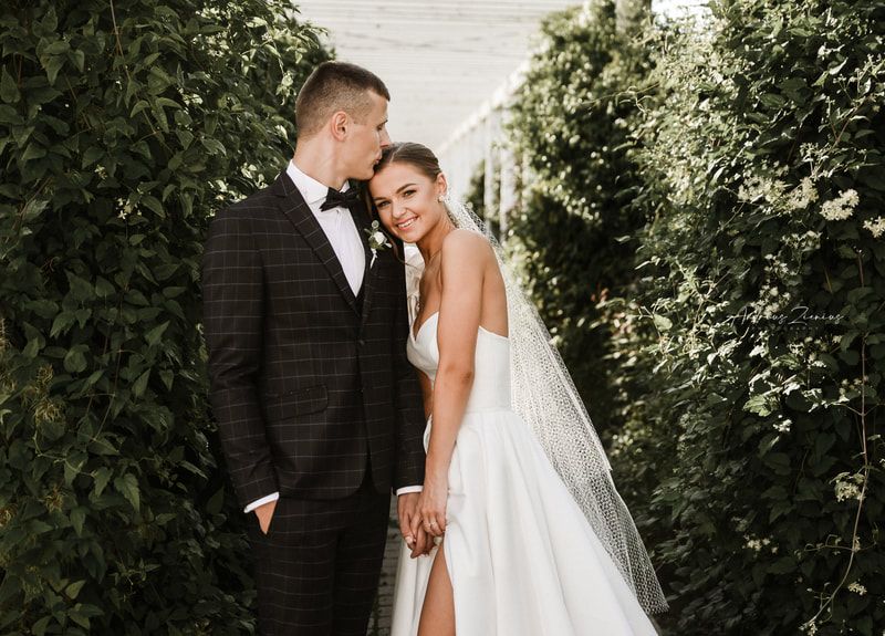 Wedding portrait series featuring couple posing against lush green garden backdrop.