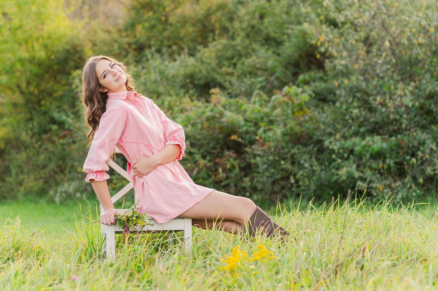 Girl sitting on a chair in a field