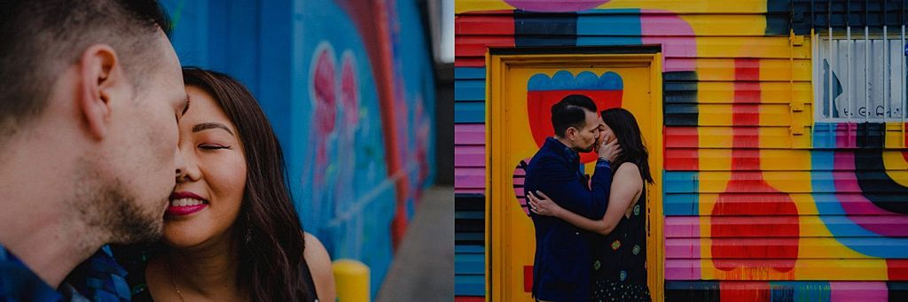 Romantic moment captured in front of colorful striped wall mural with bold patterns.