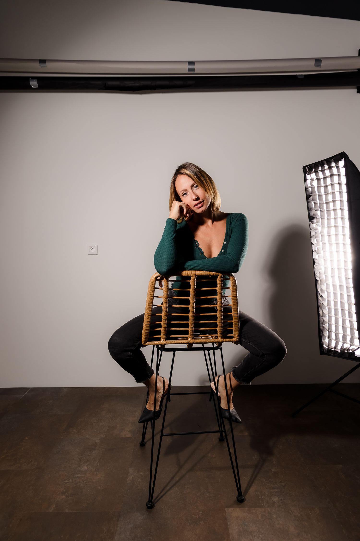 Studio photoshoot sequence showing dramatic poses with a wooden chair and professional lighting setup.