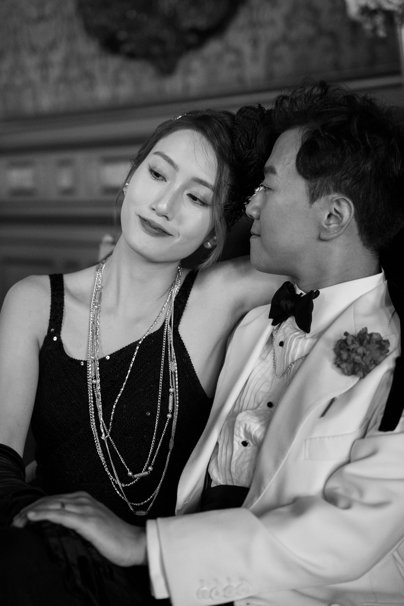 A black and white photo series showing a romantic couple in formal attire embracing in an intimate moment.