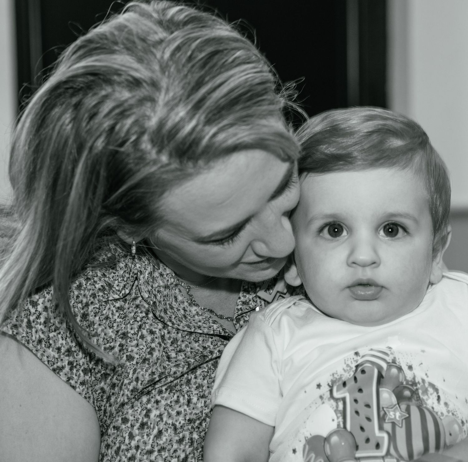 Sweet tender moments between parent and child captured in black and white sequence.