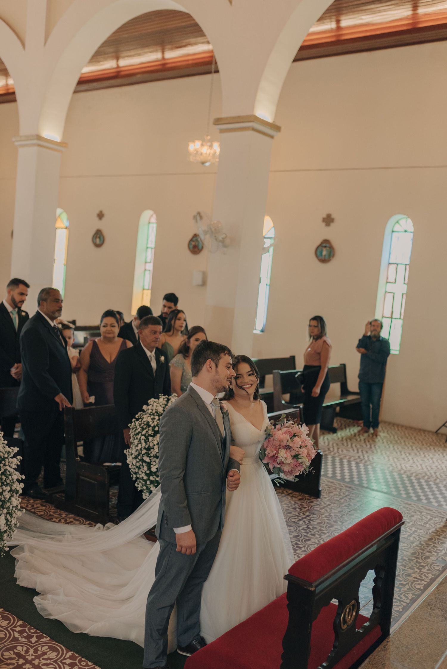 Couple during their wedding ceremony in a traditional church with elegant architectural details.