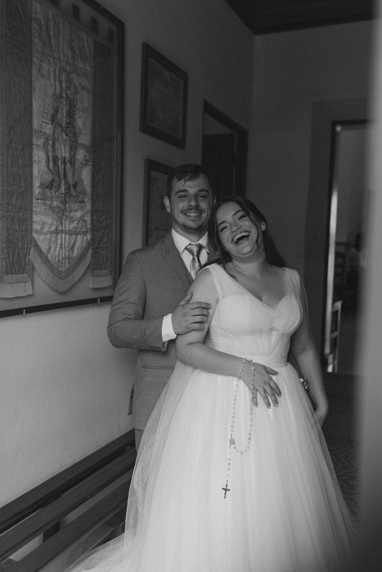 A black and white capture of a happy couple sharing a candid moment.