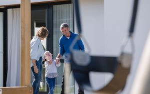 People interacting on an outdoor patio of a modern home.