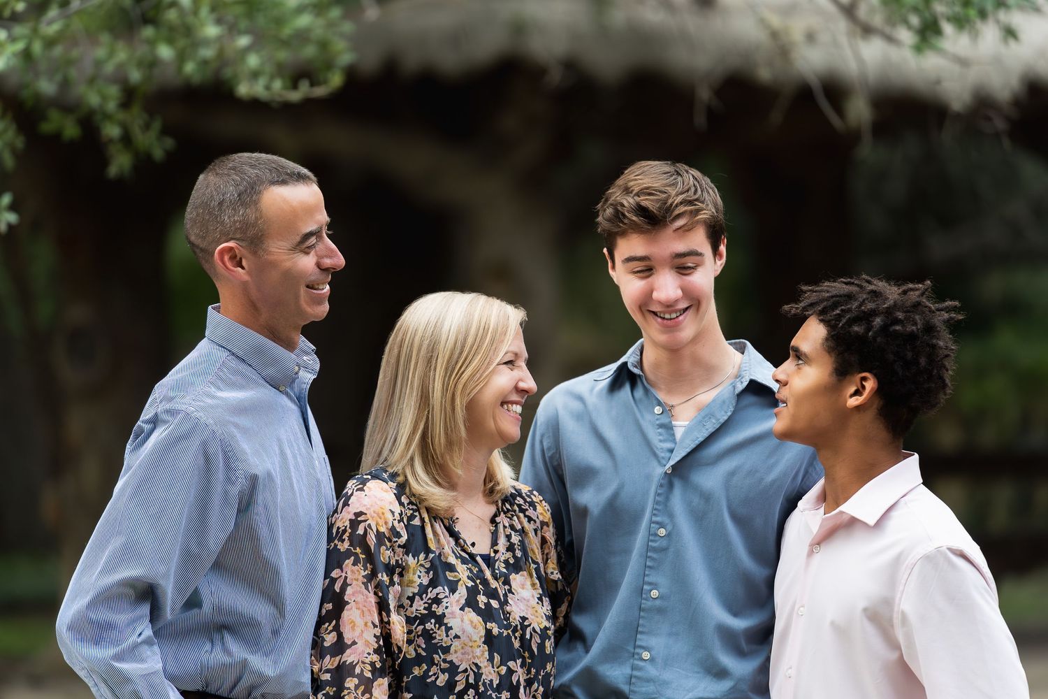 Family of four talking and laughing in Landa Gardens at Landa Library