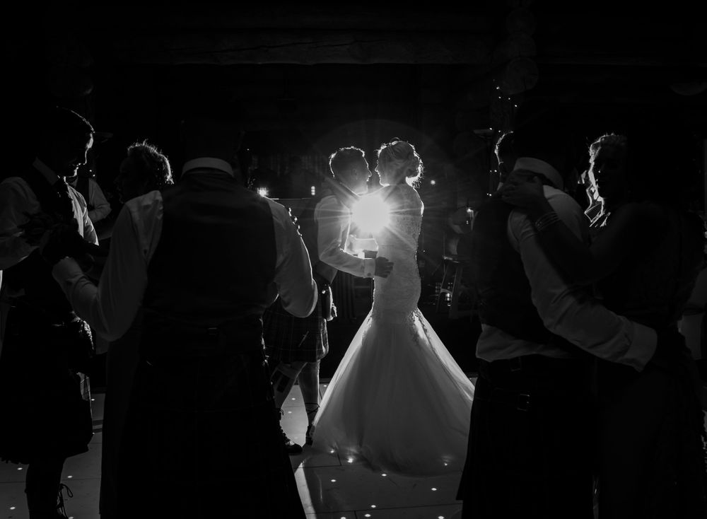 Candid Black and white wedding first dance at Piperdam Photography Angus Scotland couple in black and white dancing with off camera flash