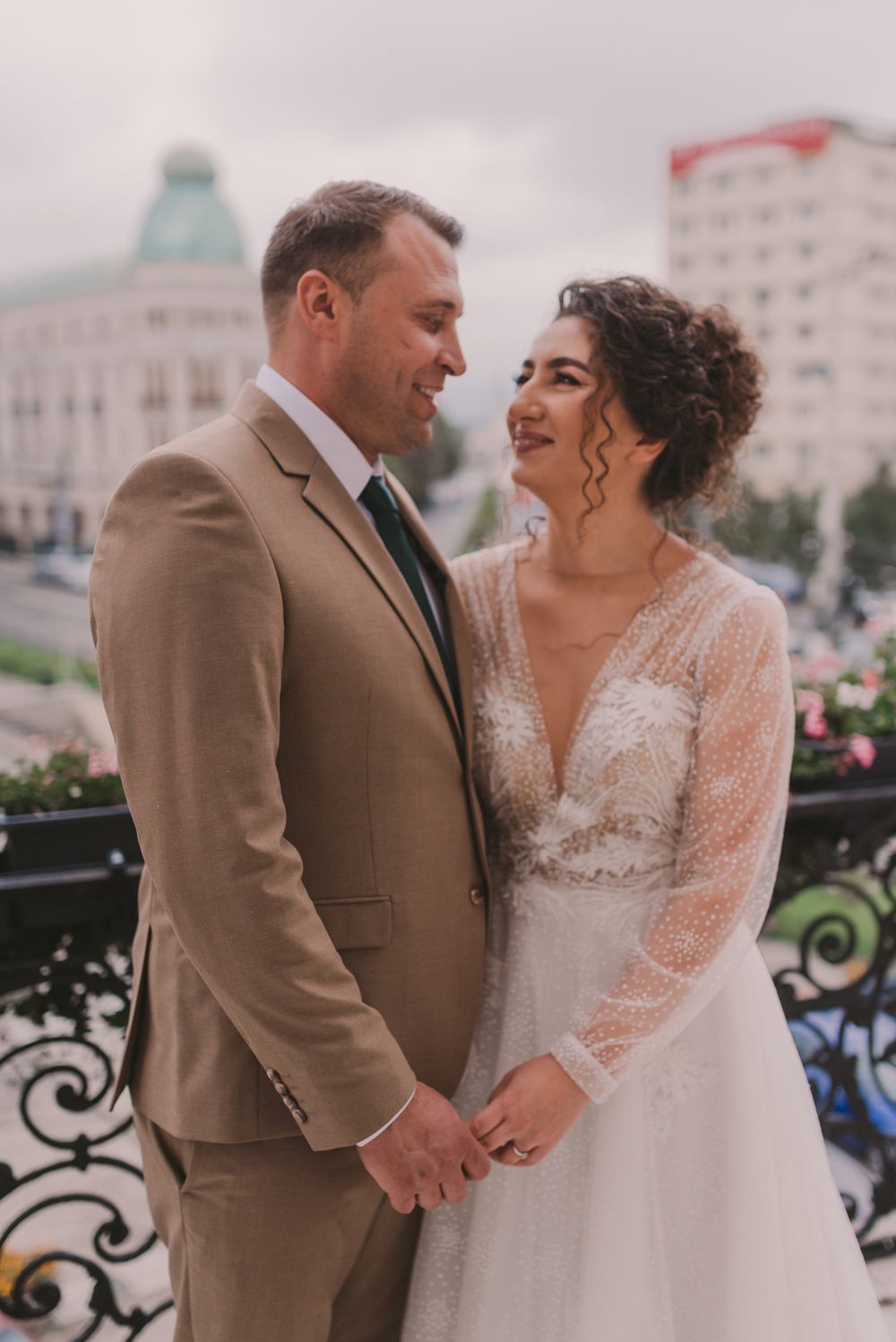 Wedding couple embraces tenderly on their special day in coordinated formal attire.