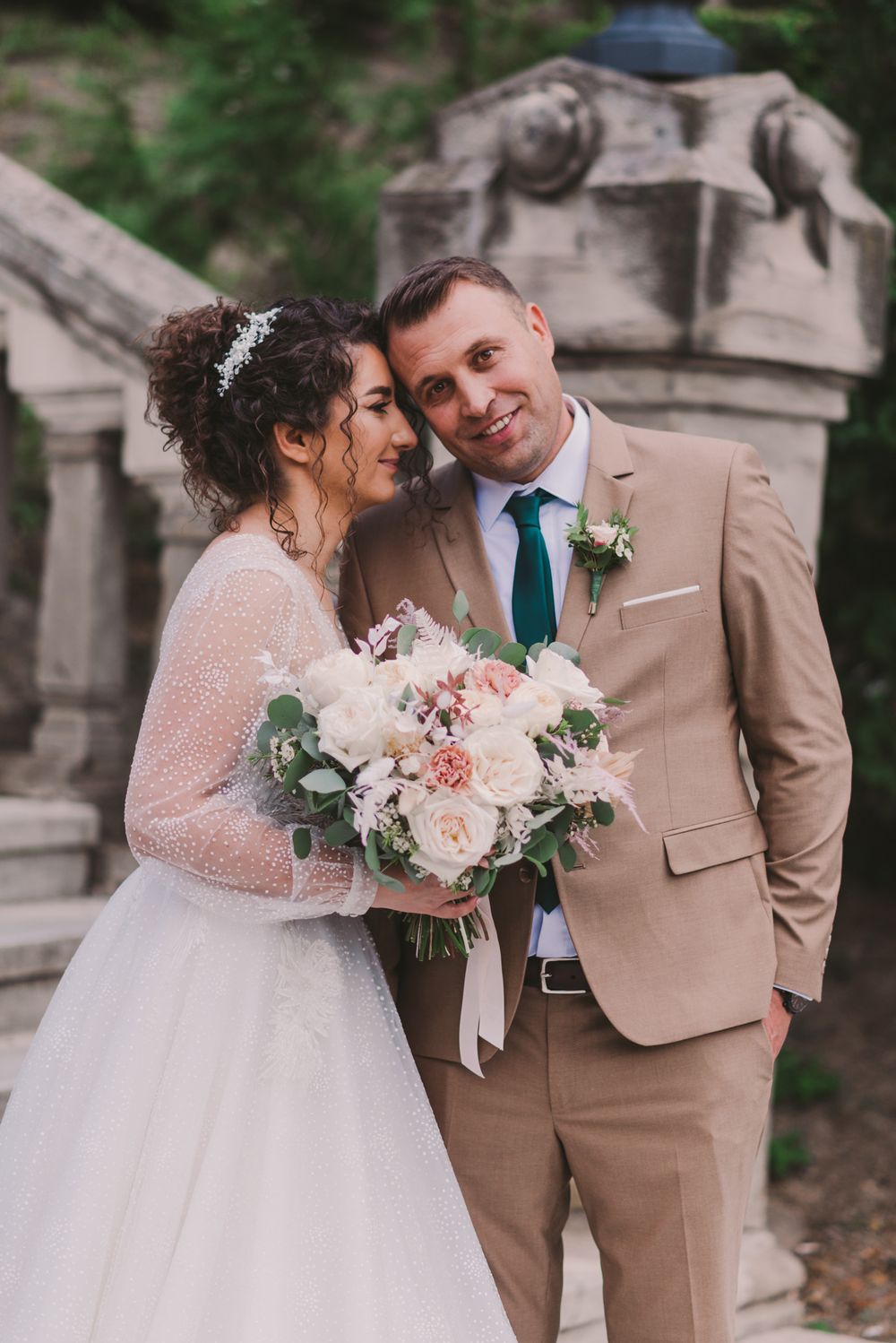 Wedding couple shares romantic moments outdoors in classic formal attire.