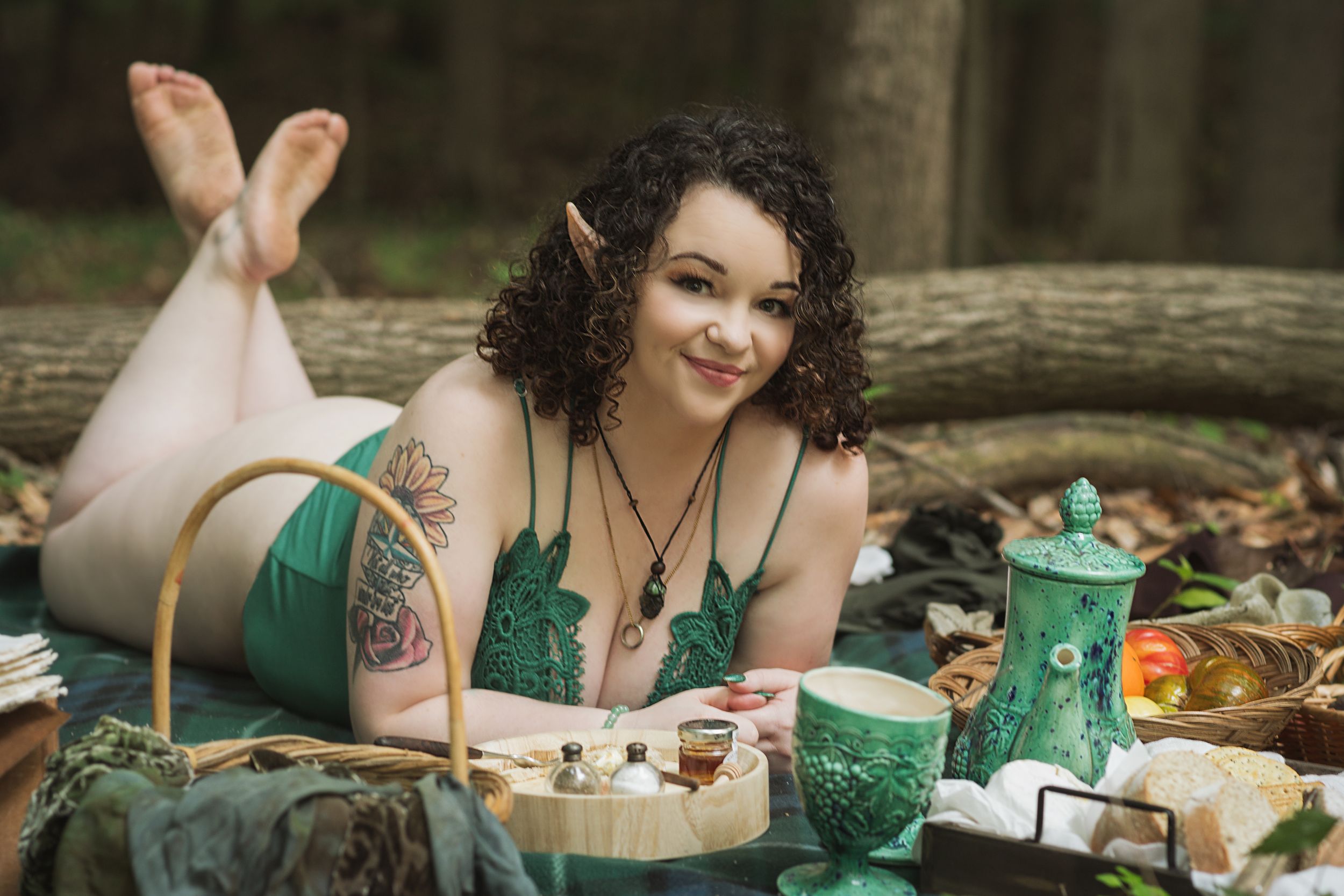Outdoor forest picnic scene with green lingerie and vintage styling.